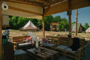 a group of benches under a tent with a teepee at Sve Mir in Boljevac