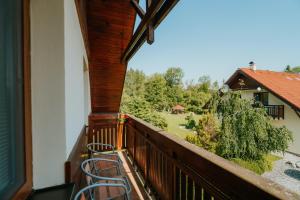 a balcony with chairs and a view of a yard at Penzion Drak in Liptovský Mikuláš