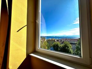 a window with a view of a city at Greif Hotel Maria Theresia in Trieste
