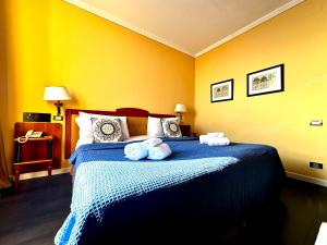 a bedroom with a bed with towels on it at Greif Hotel Maria Theresia in Trieste