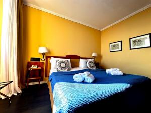 a bedroom with a bed with towels on it at Greif Hotel Maria Theresia in Trieste
