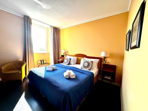 a bedroom with a bed with two stuffed animals on it at Greif Hotel Maria Theresia in Trieste