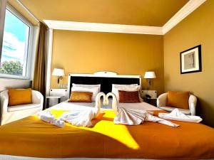 a bedroom with a large bed with swans on it at Greif Hotel Maria Theresia in Trieste