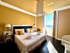 a bedroom with a large bed with a large window at Greif Hotel Maria Theresia in Trieste