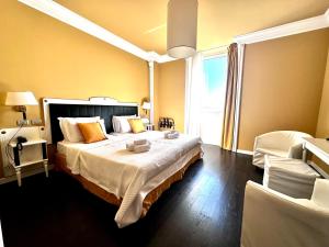 a bedroom with a large bed and a window at Greif Hotel Maria Theresia in Trieste