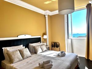 a bedroom with a large bed with a large window at Greif Hotel Maria Theresia in Trieste