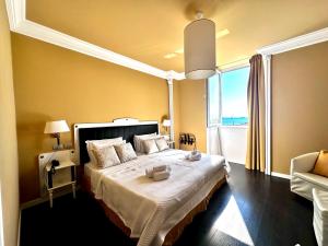 a bedroom with a large bed and a large window at Greif Hotel Maria Theresia in Trieste