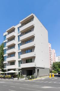 a white building on the side of a street at Central Suites in Bucharest