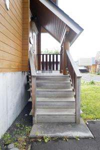 a wooden staircase leading to a porch of a house at パウダー小屋 in Kutchan +52 photos