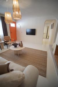 a living room with a couch and a table at Alba Terra Houses in Pamukkale