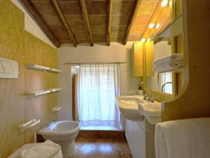 a bathroom with a sink and a toilet and a window at Le terrazze di Camollia in Siena +37 photos