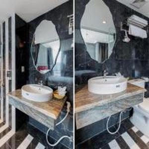 two pictures of a bathroom with a sink and a mirror at Dancenter Near Hoan Kiem Lake, Vincom Center Ba Trieu Formerly Le Grand The Sun in Hanoi