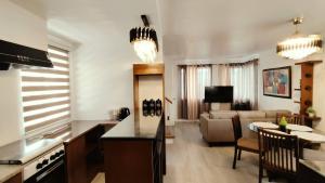 a living room with a kitchen and a living room with a couch at 3-Bedroom House in NorthPoint in Talisay