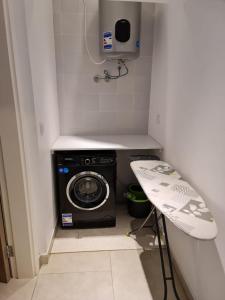 a small laundry room with a washer and dryer at Marassi Sidi Abdel Rahman in El Alamein +3 photos