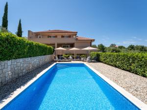 a swimming pool in front of a villa at Holiday Home Matea by Interhome in Dobrinj