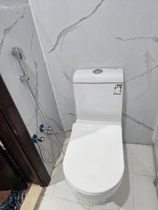 a bathroom with a white toilet in a wall at mina hotel in Riyadh