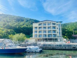 a large building with a boat docked in the water at Onyx in Eşelniţa