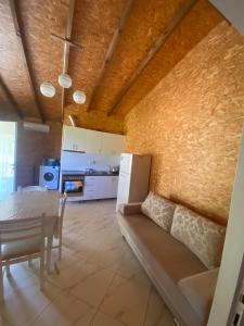 a living room with a table and a couch and a kitchen at Villa Ajla in Borsh