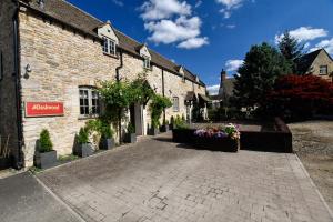a cobblestone street in front of a stone building at The Dashwood Hotel by Aziz in Kirtlington