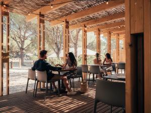 a group of people sitting at tables in a pavilion at wecamp Cádiz in Cádiz +34 photos