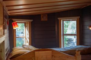 a room with two windows and a bed in it at Tyrolens vagnshotell in Alvesta