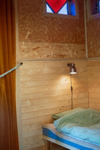 a room with a bed and a stained glass window at Tyrolens vagnshotell in Alvesta