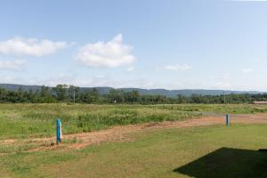 a dirt road in the middle of a field at The Cobbin Luxe, Luxe Stay Minutes from Penn State in State College