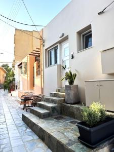 a patio with stairs in front of a house at Petra Phos in Ermoupoli