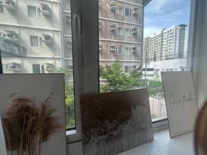 a room with three photographs in front of a window at Skylake Staycation in Manila