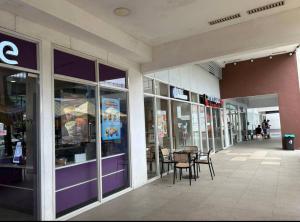 a store front with a table and chairs outside of it at Skylake Staycation in Manila