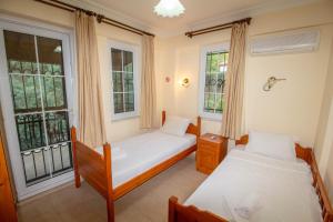 Postel nebo postele na pokoji v ubytování Brookland Paris, Özel Havuzlu, Fethiye + 28 fotografií