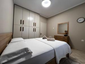 a bedroom with a large bed and a clock on the wall at Modern Makri in Makri +34 photos