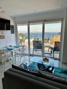 a living room with a view of the ocean at Kim Penthouse Apartment in Agia Galini