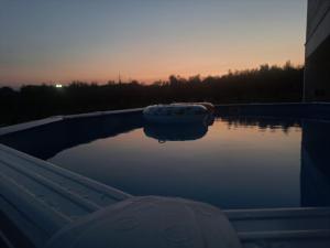 a pool of water in a boat at sunset at Casa La Giuggiola in Fiano Romano