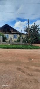 a house on the side of a dirt road at Guest House Akbermet in Bokonbayevo