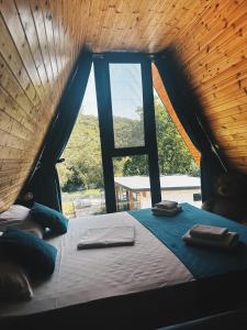 a bed in a tent with a window at Cabana Lara in Curtea de Argeş