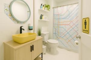 a bathroom with a sink and a mirror and a toilet at Lavender style Room in New York