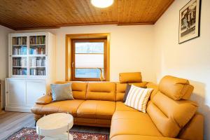 a living room with a couch and a book shelf at Ferienwohnung Tamara in Patergassen