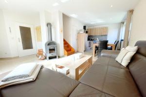 a living room with a couch and a fire place at Am Waldwinkel Ferienhaus Sonne in Koserow