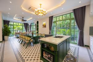 an open kitchen and dining room with a table and chairs at Fortune Villa- Swimming pool at Kem Beach Phu Quoc in Phu Quoc