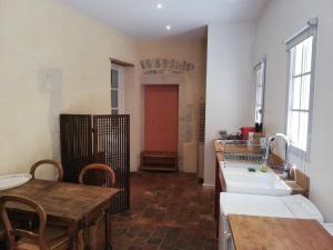 a kitchen with a table and a sink and a table and a table sidx sidx at Les Tomettes in Dole