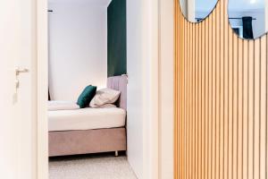 a room with a bed and a mirror at S17 Bude 8 Studio in Flensburg