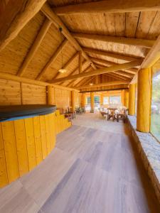 a large room with wooden ceilings and a wooden floor at Casa Valea Râului Vârciorog in Vîrciorog
