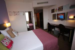 a hotel room with a bed and a desk at Hotel Floris Arlequin Grand-Place in Brussels