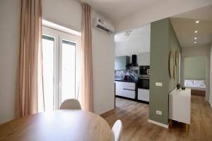 a dining room with a table and a kitchen at HC - Charming Apartment in Vigna Clara in Rome