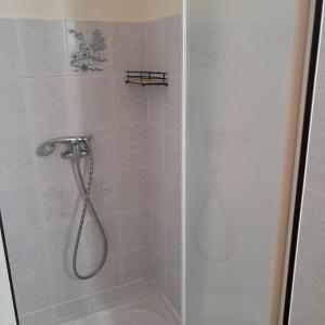 eine Dusche mit Duschkopf in einem Badezimmer in der Unterkunft La maison de la cité médiévale in Donzenac