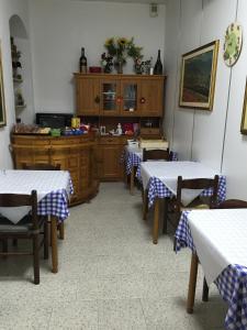 a dining room with two tables and a kitchen at Hotel Euro in Genoa