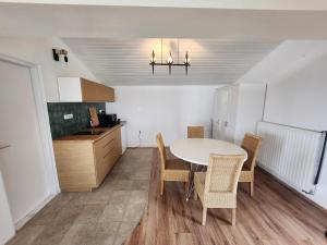 a kitchen with a table and chairs in a room at Lake Horizon in Balatonfüred +8 photos