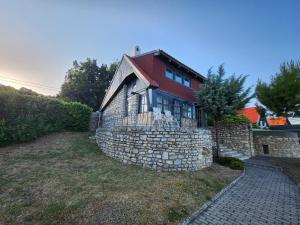 a stone wall in front of a house at Lake Horizon in Balatonfüred