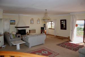 a living room with two couches and a fireplace at Genies Villa Boutique Algarve in Almancil